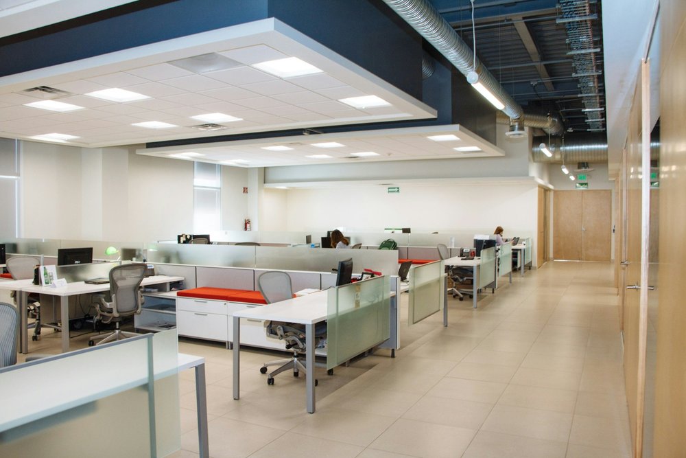 Bright open office with desks and large windows